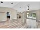 Open-concept living room flows seamlessly to the kitchen and the screened-in lanai and pool area at 13295 Don Loop, Spring Hill, FL 34609