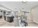 Open-concept space combining a living area with seating and a kitchen island with barstools at 13295 Don Loop, Spring Hill, FL 34609