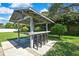 Outdoor kitchen and bar area with seating at 13295 Don Loop, Spring Hill, FL 34609