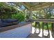 Outdoor kitchen and bar area with grill, sink, and seating at 13295 Don Loop, Spring Hill, FL 34609