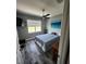 Bright bedroom featuring a large window with natural light, gray walls, and modern decor at 15301 Chinook Way, Port Charlotte, FL 33981