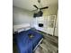 Comfortable bedroom with a bright ceiling fan, soft blue covers and plenty of storage at 15301 Chinook Way, Port Charlotte, FL 33981