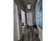 Hallway featuring neutral paint, white doors, and wood flooring leading to more rooms at 15301 Chinook Way, Port Charlotte, FL 33981