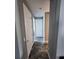 Hallway featuring neutral paint, white doors, and wood flooring that provides a clean aesthetic at 15301 Chinook Way, Port Charlotte, FL 33981