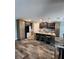 Modern kitchen featuring a center island with seating, stainless steel appliances, and tile backsplash at 15301 Chinook Way, Port Charlotte, FL 33981