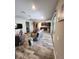 Spacious living room with wood flooring, glass tables, ceiling fan, and sliding glass doors at 15301 Chinook Way, Port Charlotte, FL 33981