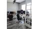 Bright office with wood-look tile flooring, multiple workstations, and lots of natural light at 15301 Chinook Way, Port Charlotte, FL 33981