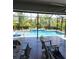Screened-in pool area with inviting pool, patio, and tropical foliage offering a private outdoor retreat at 15301 Chinook Way, Port Charlotte, FL 33981