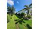 Beautifully maintained lawn with lush landscaping along the side of the house at 15301 Chinook Way, Port Charlotte, FL 33981