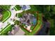 Aerial view showcasing the property with a pool, well-maintained landscaping, and neighborhood surroundings at 28707 Raleigh Pl, Wesley Chapel, FL 33545