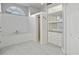 Bright bathroom featuring double vanity, tub, walk-in shower, and built-in storage shelves and cabinets at 28707 Raleigh Pl, Wesley Chapel, FL 33545