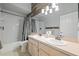 Well-lit bathroom featuring a double vanity, toilet, and bathtub with shower combo at 28707 Raleigh Pl, Wesley Chapel, FL 33545