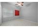 Bright bedroom featuring neutral paint, tile floor, a ceiling fan, and a large window at 28707 Raleigh Pl, Wesley Chapel, FL 33545