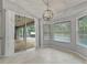 Bright dining area featuring tile flooring, large windows, and sliding doors leading to the outdoor patio and pool at 28707 Raleigh Pl, Wesley Chapel, FL 33545