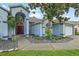 Stylish front entrance showcasing a blue exterior, a manicured landscape bed, and a well-maintained yard at 28707 Raleigh Pl, Wesley Chapel, FL 33545