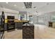 Open kitchen and breakfast nook with granite countertops, tile backsplash, and outdoor views at 28707 Raleigh Pl, Wesley Chapel, FL 33545