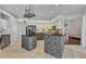 Spacious kitchen features granite countertops, modern appliances, tile floors, and brick-base island at 28707 Raleigh Pl, Wesley Chapel, FL 33545