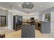 Bright and spacious kitchen with brick-base island, granite countertops, and stainless refrigerator at 28707 Raleigh Pl, Wesley Chapel, FL 33545