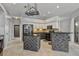 Bright kitchen with stainless appliances, granite counters, and custom stone-base breakfast bar at 28707 Raleigh Pl, Wesley Chapel, FL 33545