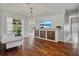 Bright living room with hardwood floors, modern wall art, and sliding glass doors opening to the pool at 28707 Raleigh Pl, Wesley Chapel, FL 33545