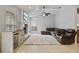 Comfortable living room with fireplace, large television, and neutral color scheme at 28707 Raleigh Pl, Wesley Chapel, FL 33545