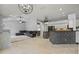 Open-concept living room with tile flooring, fireplace, and access to the kitchen at 28707 Raleigh Pl, Wesley Chapel, FL 33545