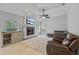 Inviting living room featuring a fireplace, large TV, and cozy seating area at 28707 Raleigh Pl, Wesley Chapel, FL 33545