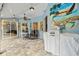 Covered patio with grill, seating, and unique Margarita mural on the wall at 28707 Raleigh Pl, Wesley Chapel, FL 33545