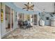 Relaxing covered patio with tiki decor, sliding glass doors, and outdoor seating at 28707 Raleigh Pl, Wesley Chapel, FL 33545