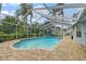Screened pool with slide surrounded by lush tropical landscaping in the backyard at 28707 Raleigh Pl, Wesley Chapel, FL 33545