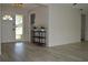 Bright foyer showcasing updated flooring, a modern display table, and a glimpse into the kitchen at 9093 108Th St, Seminole, FL 33772