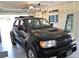Spacious garage featuring car and storage shelves at 9093 108Th St, Seminole, FL 33772