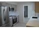 Modern kitchen featuring stainless steel appliances, sleek gray cabinetry, and ample counter space at 9093 108Th St, Seminole, FL 33772