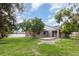 Wide shot of fenced backyard with mature shade trees offering tranquil space and privacy for outdoor living at 4358 Murdock Ave, Sarasota, FL 34231