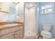 Bathroom featuring a shower stall, vanity and a modern toilet and a window to let in sunlight at 4358 Murdock Ave, Sarasota, FL 34231