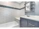 Bathroom featuring a tub and shower combination with stylish tile and updated vanity at 4358 Murdock Ave, Sarasota, FL 34231