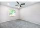 Bright bedroom with a window showing an outside view, ceiling fan, and soft carpeting at 4358 Murdock Ave, Sarasota, FL 34231