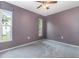 A simple bedroom featuring soft carpeting, windows, and a ceiling fan at 4358 Murdock Ave, Sarasota, FL 34231