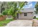 Newly renovated home with a concrete driveway, modern lighting fixtures, and a fenced yard for added privacy at 4358 Murdock Ave, Sarasota, FL 34231