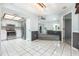 Modern kitchen featuring stainless steel appliances, white cabinetry, and a tiled floor for easy maintenance at 4358 Murdock Ave, Sarasota, FL 34231