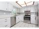 Well-appointed kitchen boasting stainless steel appliances, granite countertops, and ample white cabinet storage at 4358 Murdock Ave, Sarasota, FL 34231