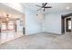 Open-concept living room with soaring ceilings, carpet, and easy access to the kitchen and dining areas at 4358 Murdock Ave, Sarasota, FL 34231