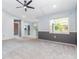 Comfortable living room offering carpet, a ceiling fan, and views of the backyard through a bright window at 4358 Murdock Ave, Sarasota, FL 34231