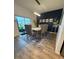 Dining area featuring modern light fixture, stylish decor, and sliding glass doors at 10302 Lavender Aster Trl, San Antonio, FL 33576