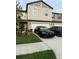 Inviting two-story townhouse with attached garage, landscaped yard, and well-manicured lawn at 10302 Lavender Aster Trl, San Antonio, FL 33576