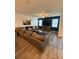 Comfortable living room with a cozy sectional sofa, ceiling fan, and natural light at 10302 Lavender Aster Trl, San Antonio, FL 33576