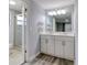 Bathroom with a double sink vanity and glass enclosed shower at 9516 Woodborough Ct, Tampa, FL 33615