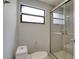 Bathroom features a modern glass shower and toilet at 9516 Woodborough Ct, Tampa, FL 33615