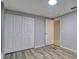 Bedroom featuring wood-look floors, gray walls, and a closet with standard bi-fold doors at 9516 Woodborough Ct, Tampa, FL 33615