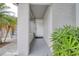 The front door is accessible via a covered porch, which also features a bench and decorative plants for added curb appeal at 9516 Woodborough Ct, Tampa, FL 33615